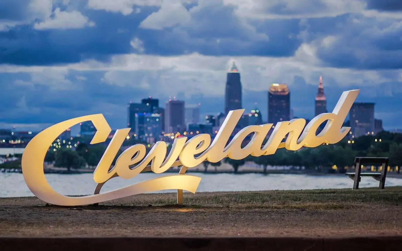 Cleveland script sign with the downtown skyline at dusk